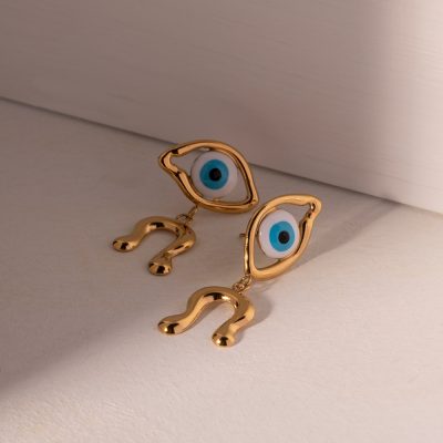Stylish gold-tone earrings featuring blue eye charms and question mark pendants, perfect for protection and fashion. Unique jewelry piece from Monalisa Medical Store.