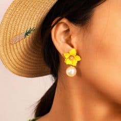 Pearl and yellow flower dangle earring in a close-up shot, perfect for summer fashion and accessories.