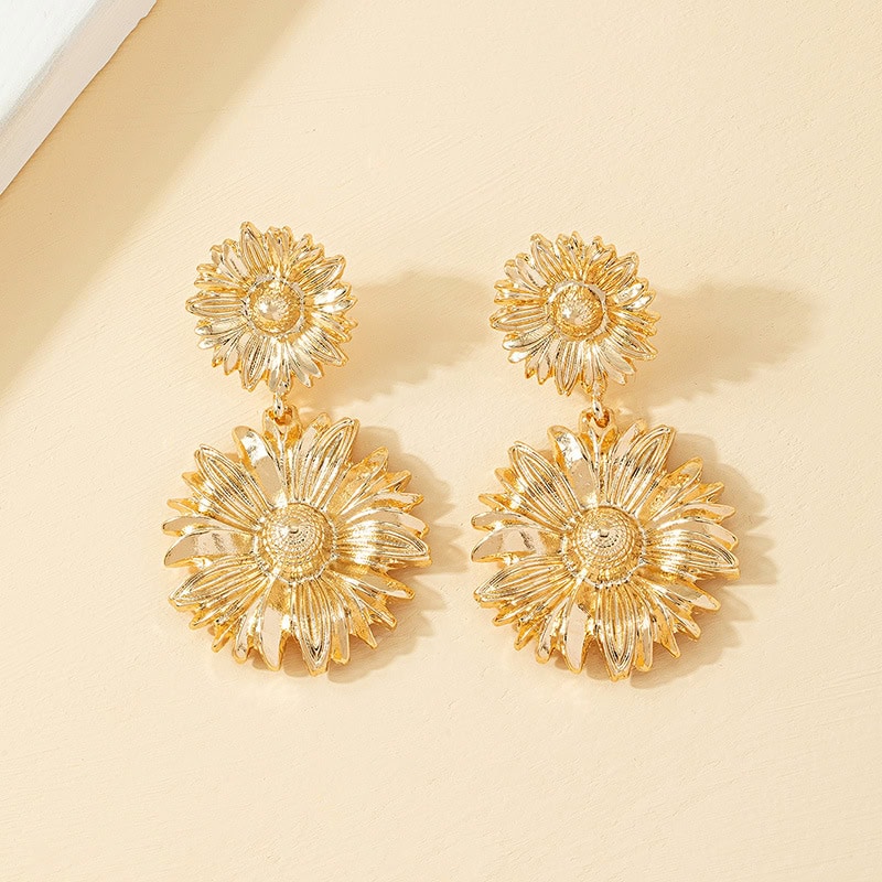 Elegant flower-shaped gold earrings for women, perfect for fashion accessories and jewelry collections. Bright, trendy, and stylish floral statement earrings.