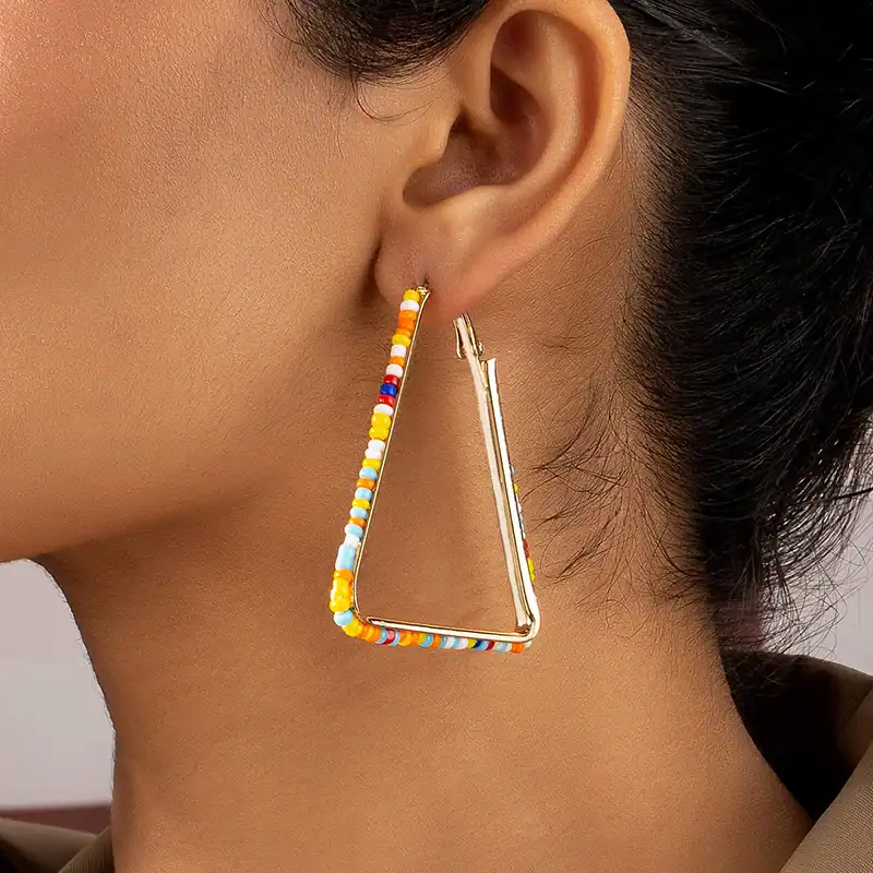 Vibrant beaded hoop earring for women, stylish jewelry accessory, perfect for adding a pop of color to your look.