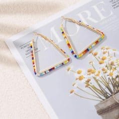 Bright triangle earrings with multicolored bead accents, perfect for stylish accessory choices. Durable gold-tone hooks ideal for everyday wear and special occasions.