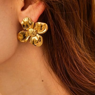 Close-up of a stunning gold flower-shaped earring designed for women, emphasizing stylish jewelry.