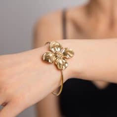 Luxurious gold flower bracelet with intricate detailing, perfect for stylish women seeking designer jewelry from Monalisa Medical.