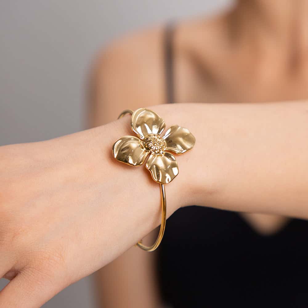 Luxurious gold flower bracelet with intricate detailing, perfect for stylish women seeking designer jewelry from Monalisa Medical.