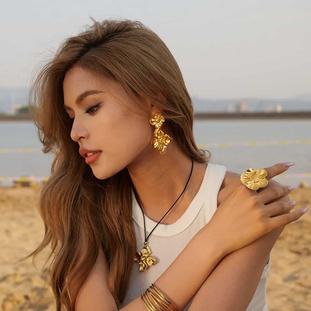 Stunning gold jewelry collection featuring earrings, necklace, ring, and bangles from Monalisa Store, perfect for fashion-forward women seeking sophisticated accessories.