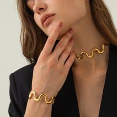 Suitable for women who want modern, stylish jewelry. Featuring a gold wavy necklace and matching bracelet, perfect for enhancing any outfit with luxury accessories.