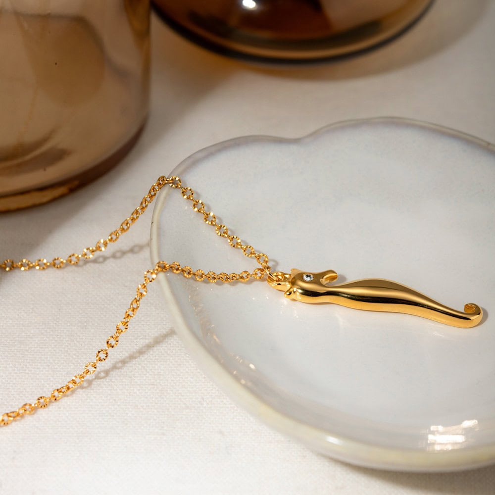Luxurious gold necklace with delicate chain and elegant pendant featuring a small diamond for women’s jewelry collection.