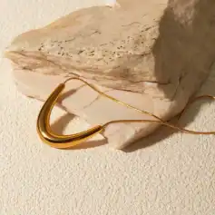 Luxurious gold necklace displayed on a textured background, ideal for women seeking stylish jewelry at Monalisa Store, perfect for enhancing your fashion and jewelry collection.