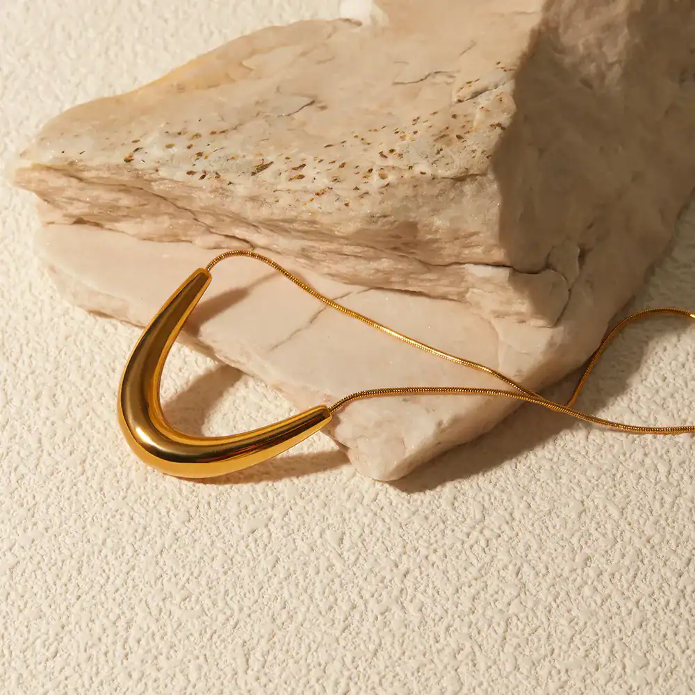 Luxurious gold necklace displayed on a textured background, ideal for women seeking stylish jewelry at Monalisa Store, perfect for enhancing your fashion and jewelry collection.