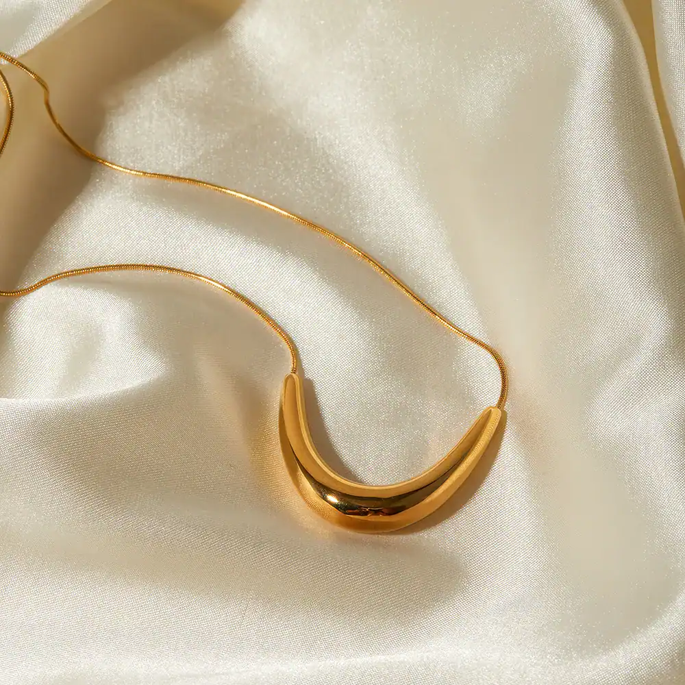 A luxurious gold necklace displayed on silky satin fabric, perfect for jewelry shopping and enhancing your style.