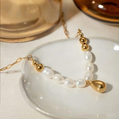 Pearl and gold necklace showcasing lustrous white pearls and shiny gold beads, perfect for elegant jewelry collections and stylish accessories.