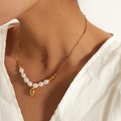 Beautiful pearl and gold chain necklace perfect for elegant occasions, highlighted by a teardrop pendant, offering a luxurious accessory for special events or everyday classy wear.