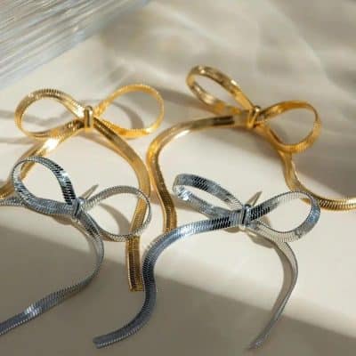 Stylish gold and silver bow-shaped jewelry accessories for women, perfect for fashion statements and matching with any outfit. Crafted with high-quality materials for a chic look.