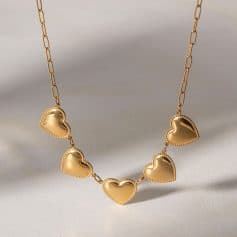 Elegant gold heart necklace featuring multiple heart pendants on a delicate chain, perfect for adding a romantic touch to your accessories collection.