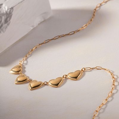 Delicate gold chain necklace with heart-shaped pendants, perfect for women seeking fine jewelry. Shop stylish, high-quality necklaces at Monalisa Store, your go-to for fashionable accessories.