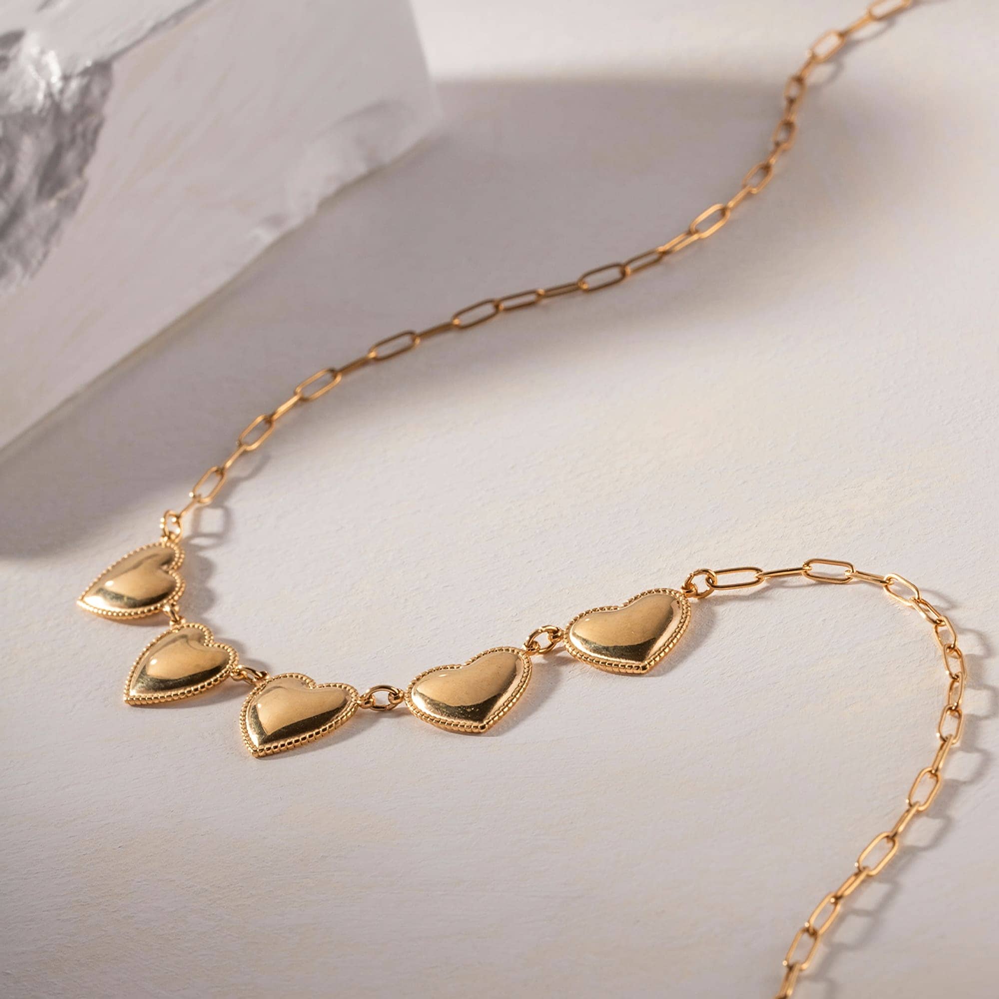 Delicate gold chain necklace with heart-shaped pendants, perfect for women seeking fine jewelry. Shop stylish, high-quality necklaces at Monalisa Store, your go-to for fashionable accessories.