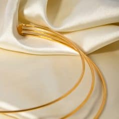 Stylish gold hair clip on silky satin fabric, perfect for hair accessories and fashion styling. High-quality, shiny gold, ideal for women’s hair accessories and beauty products.