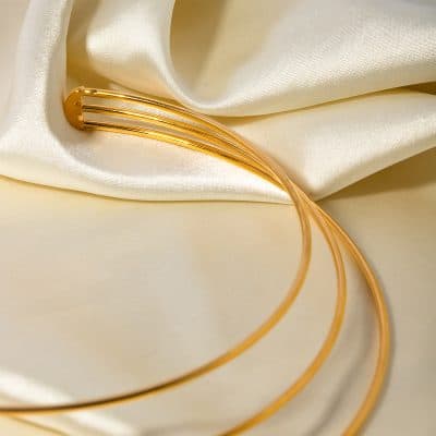 Stylish gold hair clip on silky satin fabric, perfect for hair accessories and fashion styling. High-quality, shiny gold, ideal for women’s hair accessories and beauty products.