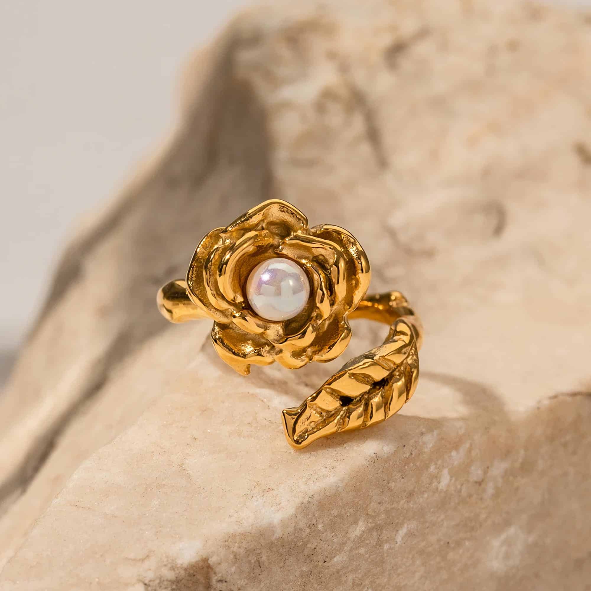 Luxurious gold ring featuring a detailed flower design with a central pearl, perfect for stylish women seeking high-quality jewelry.