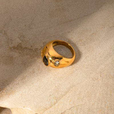 Elegant gold ring featuring black and clear gemstones, perfect for stylish accessories and jewelry collection. Crafted with high-quality materials, suitable for special occasions.