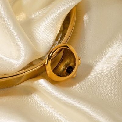 A close-up of a gold bracelet and ring against luxurious satin fabric, highlighting fine jewelry designs available at Monalisa Store for stylish accessories and fashionable jewelry.
