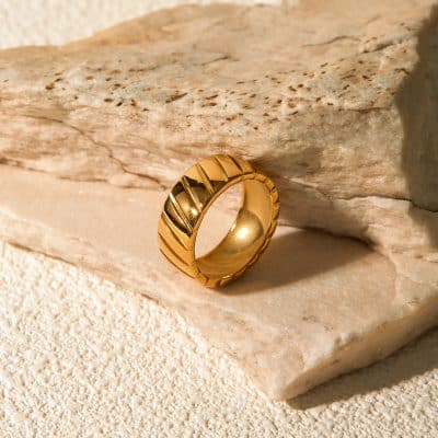 Luxurious gold ring with a sleek design, perfect for stylish accessories or wedding bands, available at Monalisa Store.