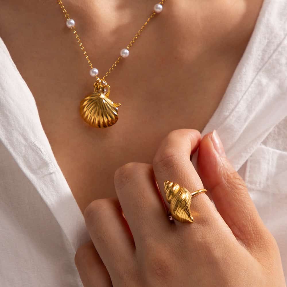 Beautiful gold shell pendant necklace with pearl details and matching shell ring, perfect for enhancing your jewelry collection.
