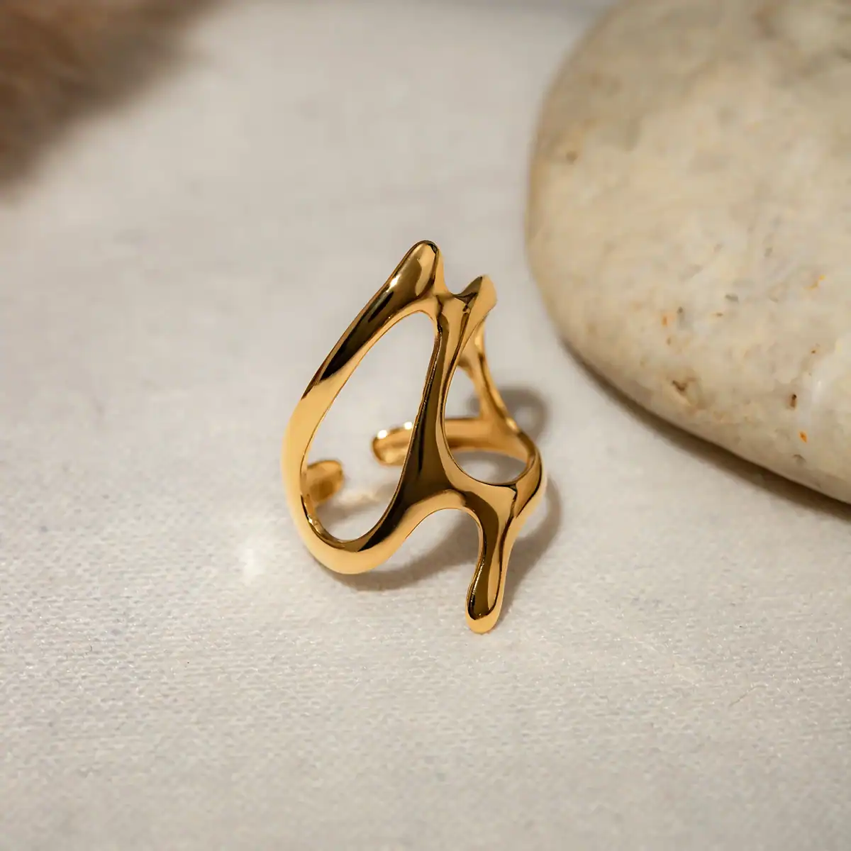 Stunning gold ring with an artistic, abstract design, perfect for stylish women seeking unique jewelry for special occasions or everyday wear.