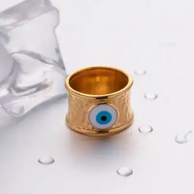 A gold-tone ring featuring a prominent blue evil eye symbol, designed to ward off negative energies and protect the wearer. Perfect for those seeking stylish protection jewelry.