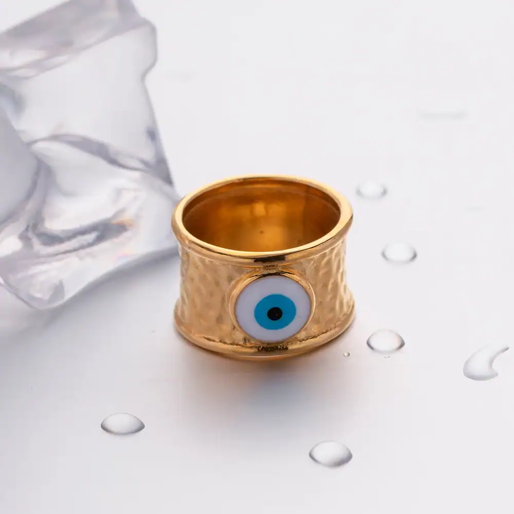 A gold-tone ring featuring a prominent blue evil eye symbol, designed to ward off negative energies and protect the wearer. Perfect for those seeking stylish protection jewelry.