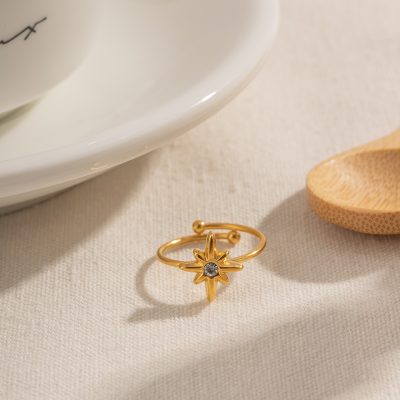 Elegant gold star ring with gemstone detail for women’s jewelry. Perfect accessory for daily wear or special occasions, showcasing unique design and craftsmanship.
