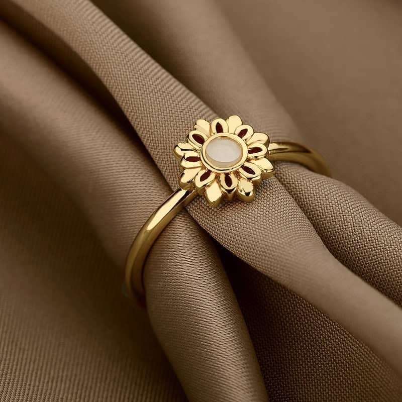 Gold flower-shaped ring with a central white stone, perfect for stylish accessories and elegant fashion statements. Crafted with high-quality materials for durability and sophistication.
