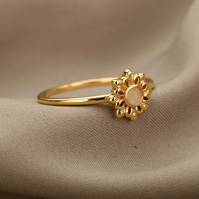 Delicate gold ring featuring a floral design with a central pearl, perfect for elegant occasions or everyday wear, from Monalisa Store.