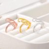 Stunning set of crystal-adorned rings in rose gold, yellow gold, and silver, perfect for enhancing your jewelry collection and making a stylish statement.