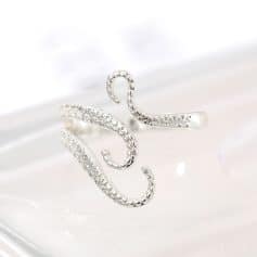 Delicate silver ear cuff shaped like an octopus with sparkling eye details, perfect for stylish accessories and ear jewelry lovers.