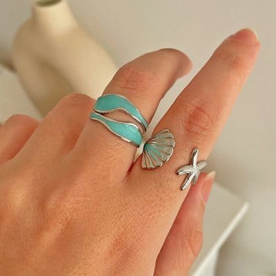 Stylish turquoise and silver ocean-themed rings perfect for women’s jewelry collection, showcasing unique sea-inspired designs including shells and starfish.