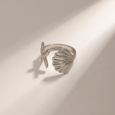 Sterling silver ring featuring a starfish and scallop shell motif, perfect for beach-inspired jewelry lovers and coastal fashion accessories.