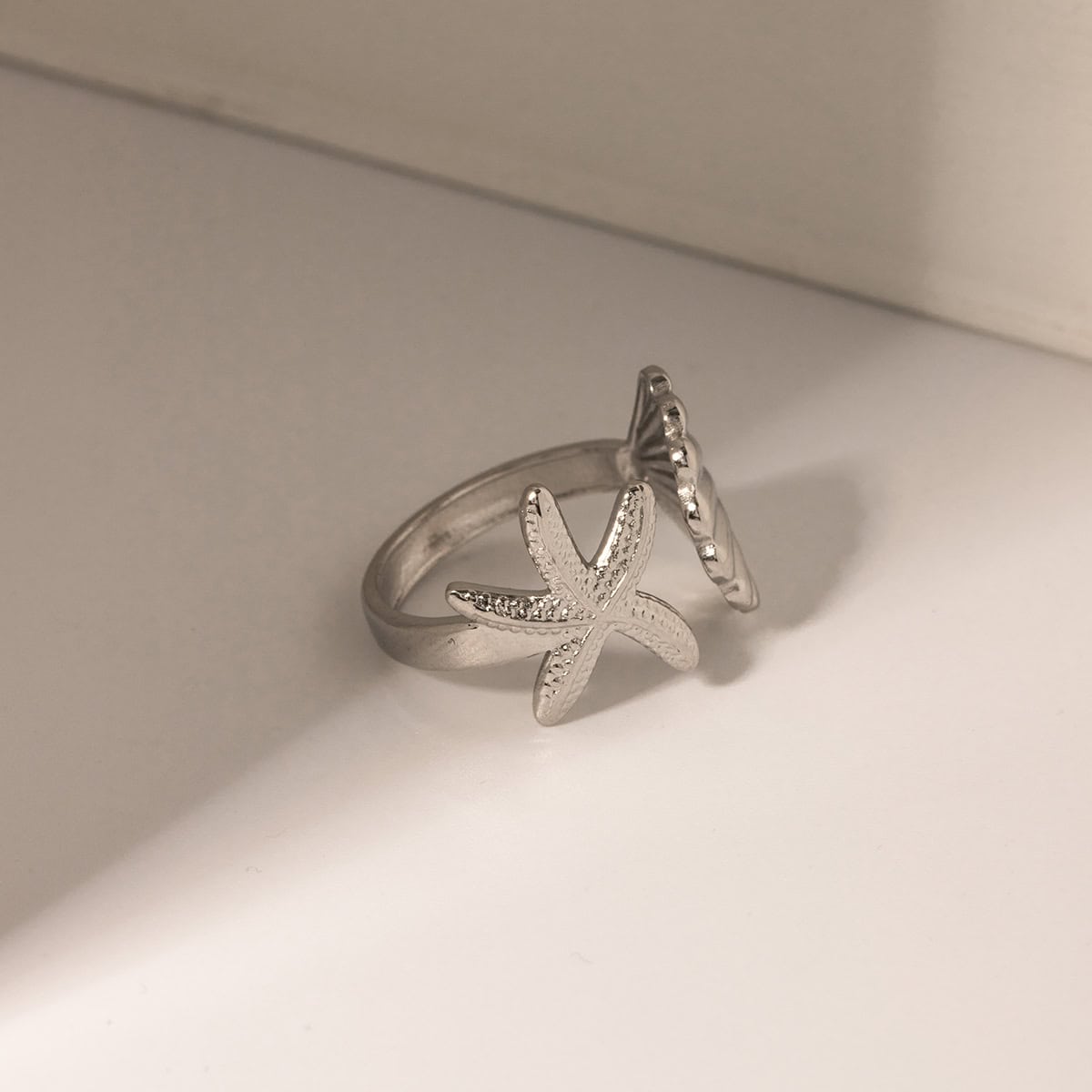 Elegant silver starfish-shaped ring with embedded crystals, perfect for beach-inspired jewelry lovers and everyday wear. Shop stylish, high-quality jewelry at Monalisa Store.