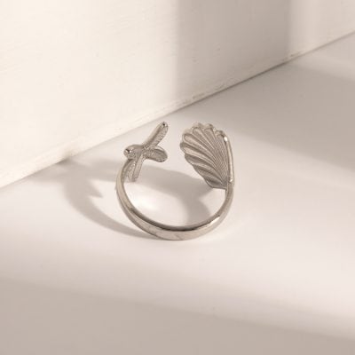 Silver jewelry, shell-shaped design, cross detail, minimalist style, trendy accessories, monalisa medical store, fashionable ring for women, durable silver ring, stylish jewelry gift option, unique jewelry piece, versatile accessory, handcrafted silver ring.