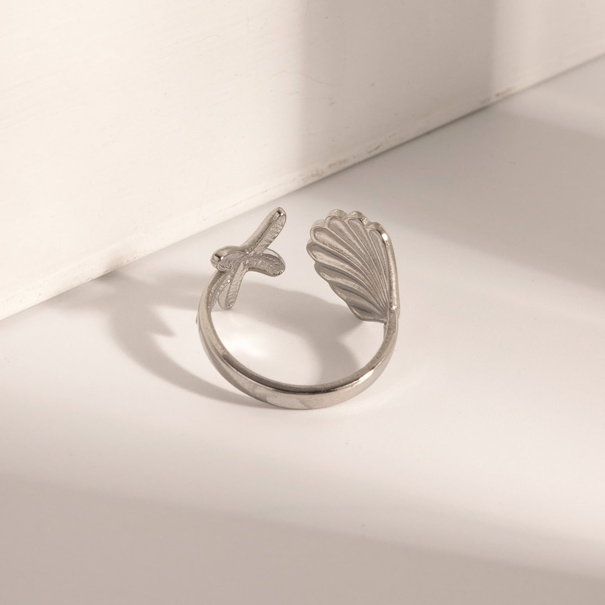 Silver jewelry, shell-shaped design, cross detail, minimalist style, trendy accessories, monalisa medical store, fashionable ring for women, durable silver ring, stylish jewelry gift option, unique jewelry piece, versatile accessory, handcrafted silver ring.