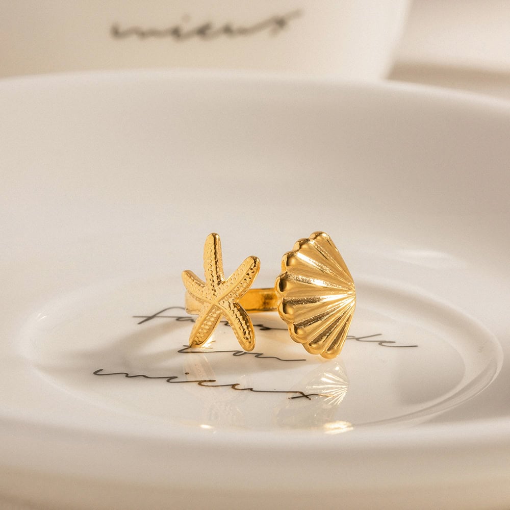 Elegant gold starfish and shell design jewelry, perfect for beachwear and summer accessories. Unique statement ring for women, crafted with high-quality gold material.