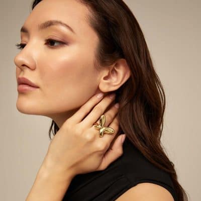 Beautiful woman with gold jewelry, showcasing trendy accessories available at Monalisa Medical's jewelry store, ideal for fashion and gift ideas.