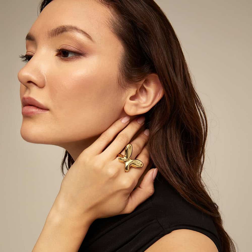 Beautiful woman with gold jewelry, showcasing trendy accessories available at Monalisa Medical's jewelry store, ideal for fashion and gift ideas.