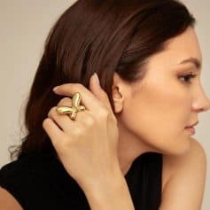 Stylish woman wearing a unique gold butterfly ring, close-up portrait emphasizing jewelry accessories from Monalisa Store’s collection, perfect for luxury jewelry lovers.