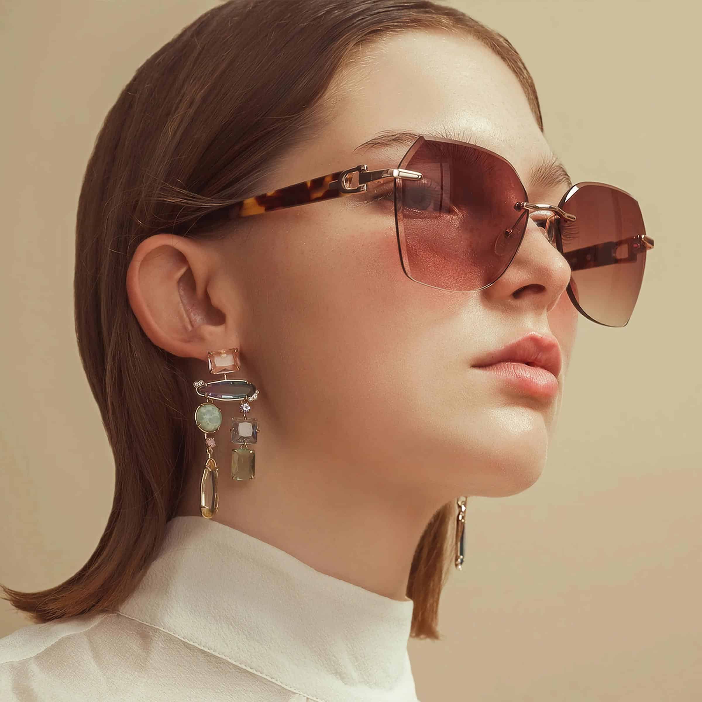 Elegant sunglasses with gradient lenses and tortoiseshell arms, paired with statement earrings, showcasing fashion accessories at Monalisa Store for a chic and trendy look.
