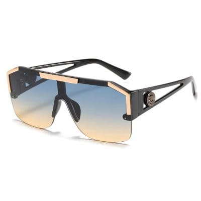 Stylish black and gold designer sunglasses with gradient tinted lenses for UV protection, perfect for fashion-forward optometry customers and enhancing outdoor vision.