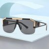 High-quality luxury sunglasses featuring black and gold detailing, UV-protective dark lenses, perfect for fashion-forward individuals seeking premium eyewear.