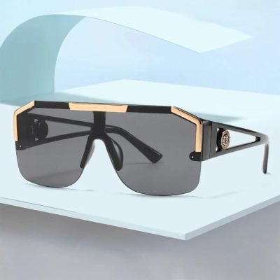 High-quality luxury sunglasses featuring black and gold detailing, UV-protective dark lenses, perfect for fashion-forward individuals seeking premium eyewear.