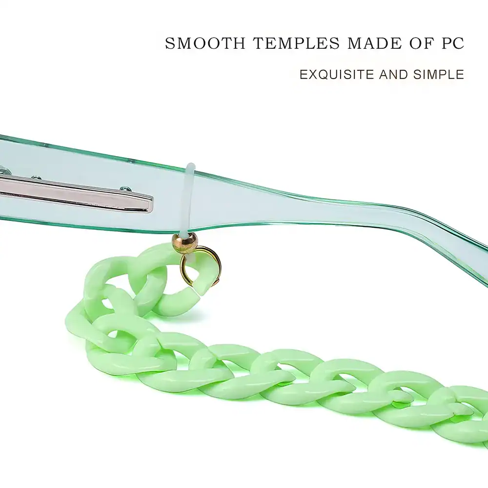 Close-up of a light green chunky chain necklace with a glass frame, emphasizing stylish accessories. Perfect for jewelry enthusiasts.