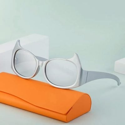 Elegant sunglasses on an orange case with minimalistic background, showcasing stylish optical accessories from Monalisa Store for trendy vision solutions.